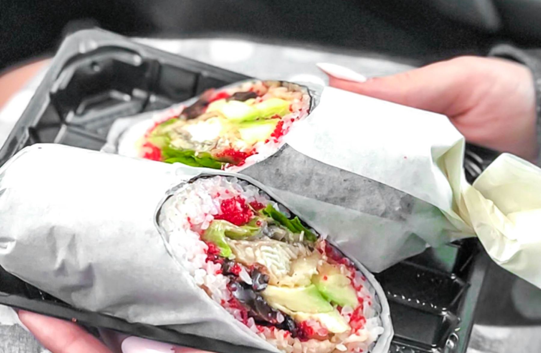a sushi burrito in hands